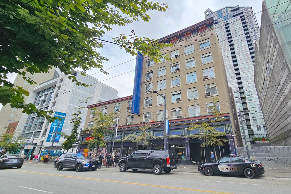 A police incident at the Luugat (former Howard Johnson hotel), turned into a supportive housing site, at the Granville Entertainment District in downtown Vancouver on July 25, 2025. (Kenneth Chan)