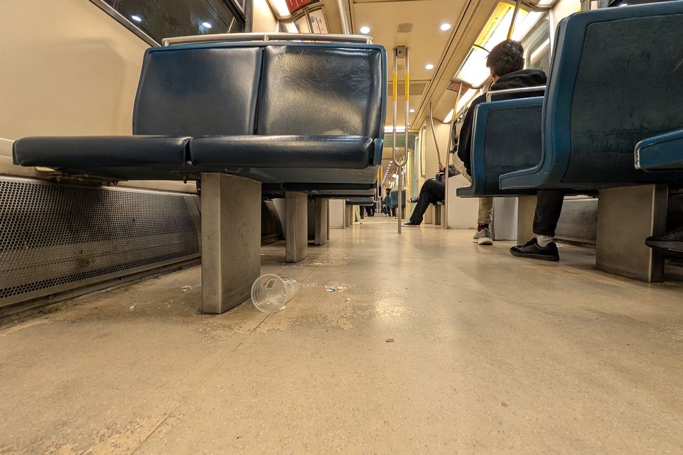 A SkyTrain car interior with cleanliness issues and garbage. (Kenneth Chan)